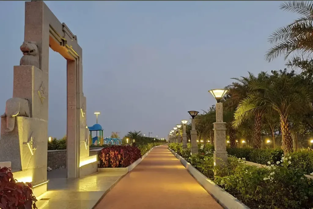 Tree-lined pathway and statues along Tank Bund Road by the lake