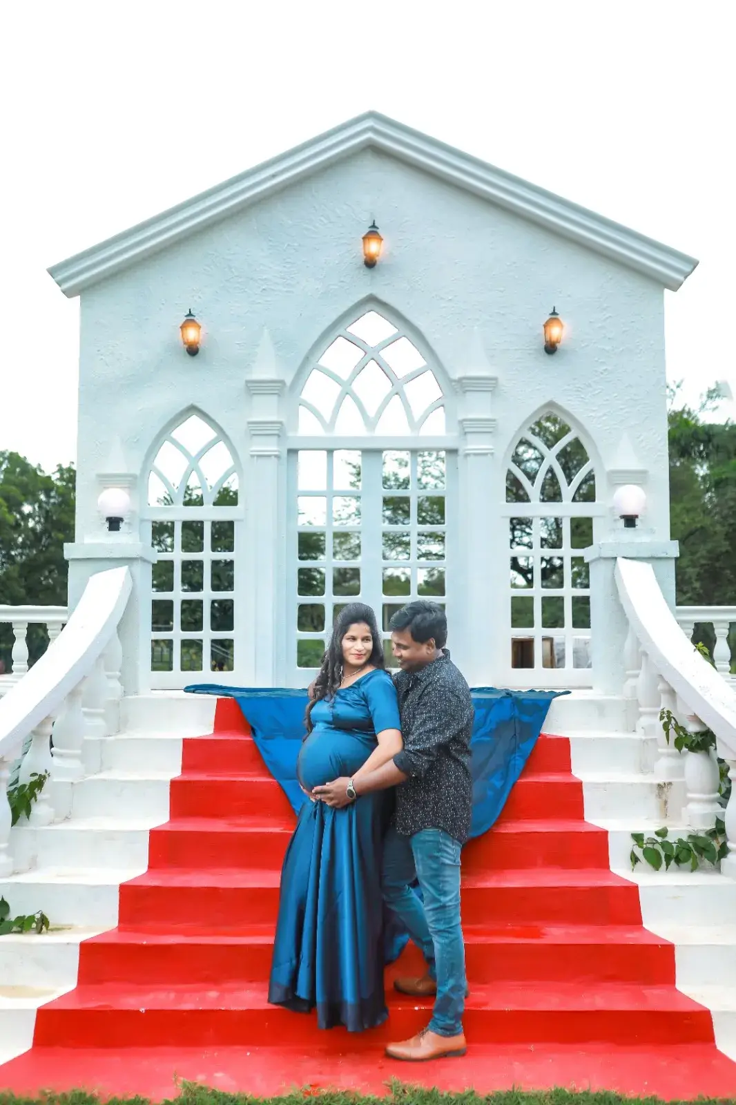 Couple maternity photoshoot on white chapel stairs – Maternity Photoshoot in Hyderabad