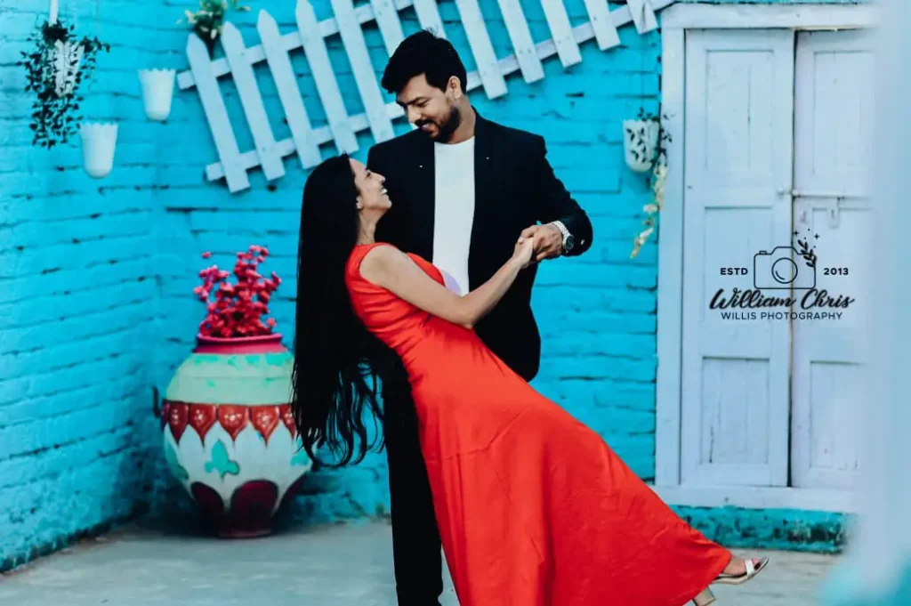Couple leaning on green doorframe set for pre wedding shoot in Hyderabad