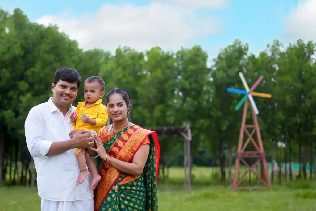 Happy family photoshoot in Hyderabad with outdoor windmill backdrop.