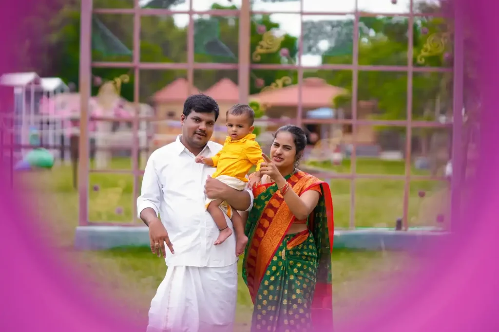 Family photoshoot in Hyderabad with colorful pink backdrop.